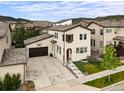 Aerial view showcasing this charming two-story home with a basketball hoop over the garage and mountain views at 15547 W Vassar Ave, Lakewood, CO 80228