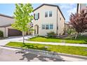 Charming two-story home featuring a well-manicured front yard at 15547 W Vassar Ave, Lakewood, CO 80228