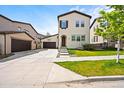Charming two-story home featuring a basketball hoop over the garage and well-manicured front yard at 15547 W Vassar Ave, Lakewood, CO 80228