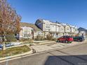 Tan and white townhomes with off-street parking for residents at 5888 Biscay St # D, Denver, CO 80249