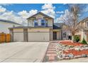 Two-story home featuring a three car garage, neat landscaping, and mature trees at 21455 E 44Th Ave, Denver, CO 80249