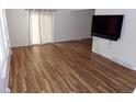 A bright living room with wood floors and a large window offers plenty of natural light and an entertainment area at 1015 Alta St, Longmont, CO 80501