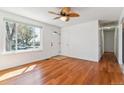 Bright living room featuring hardwood floors, fresh white paint, and a ceiling fan at 3195 S Kalispell Ct, Aurora, CO 80013