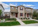 Charming two-story home with neutral siding, red shutters, and inviting front yard landscaping at 21833 E Quincy Pl, Aurora, CO 80015