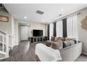 Living room with gray modern sofa and hardwood flooring at 21833 E Quincy Pl, Aurora, CO 80015