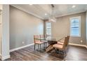 Bright dining room with glass table and hardwood floors at 6938 S Riverwood Way, Aurora, CO 80016