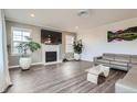 Spacious living room with fireplace and hardwood floors at 6938 S Riverwood Way, Aurora, CO 80016