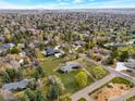Panoramic aerial view of a residential area with lush greenery, mature trees, and well-maintained lawns on a sunny day at 4901 Redwood Dr, Littleton, CO 80123