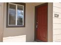 Close-up of the front door, showcasing its rich color and adjacent window for natural light at 1750 Jamaica St, Aurora, CO 80010