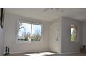 Bright living room with large windows, tile floors, and ample natural light at 1750 Jamaica St, Aurora, CO 80010