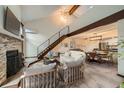 Open-concept living room features a fireplace, high ceilings, and easy access to the dining area and kitchen at 23566 Pondview Pl # F, Golden, CO 80401