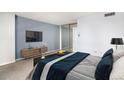 Comfortable bedroom with modern furnishings, a mirrored closet, and blue accents at 1020 15Th St # 7A, Denver, CO 80202