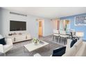 Inviting living and dining room area with light gray flooring, modern decor, and updated furnishings at 1020 15Th St # 7A, Denver, CO 80202
