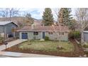 Attractive single-Gathering home with fresh landscaping, mature trees, and a blue accent garage at 3545 Cloverleaf Dr, Boulder, CO 80304