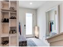 Bright foyer with storage, bench, full length mirror and modern accents at 8361 Parkland St, Broomfield, CO 80021