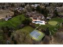 Aerial view of a luxurious home with a pool, sports court, and meticulously landscaped grounds at 4475 S Downing St, Cherry Hills Village, CO 80113