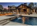 A stunning pool with a cascading waterfall adds a touch of luxury to the outdoor space at 4475 S Downing St, Cherry Hills Village, CO 80113