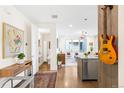 Inviting entryway with hardwood floors, a small table, a guitar, and a view into the living room at 1333 Elati St # 1, Denver, CO 80204