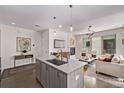 Open-concept kitchen featuring an island with views of the living room and fireplace at 1333 Elati St # 1, Denver, CO 80204