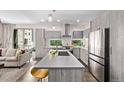 Open-concept kitchen with modern appliances and an island adjacent to the living area at 1333 Elati St # 1, Denver, CO 80204