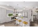Well-lit kitchen with stainless steel appliances, island with barstool seating, and pendant lights at 1333 Elati St # 1, Denver, CO 80204