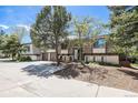 A home with a spacious driveway, mature trees, and unique architectural details at 9349 E Chenango Ave, Greenwood Village, CO 80111