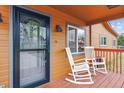 Inviting front porch with rocking chairs, a wreath on the door and wood accents at 176 W Elm St, Elizabeth, CO 80107