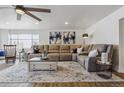 Bright living room featuring a large sectional sofa, area rug, and ample natural light at 176 W Elm St, Elizabeth, CO 80107