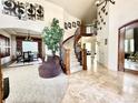Elegant foyer with a curved staircase, high ceilings, neutral tones, and stylish decor elements at 13970 Craig Way, Broomfield, CO 80020