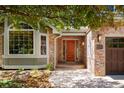 Inviting front entrance with a solid wood door, brick accents, and a well-lit walkway at 2345 Spotswood Pl, Boulder, CO 80304