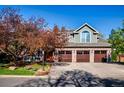 Beautiful home exterior showcasing a three-car garage, brick accents, and mature trees on a sunny day at 2345 Spotswood Pl, Boulder, CO 80304