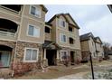 Close up view of a lovely condominium complex, showing the building number and architecture at 8369 S Independence Cir # 205, Littleton, CO 80128
