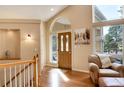Welcoming foyer with hardwood floors, arched doorway, large windows, and ample natural light at 740 W Lancers Ct, Monument, CO 80132