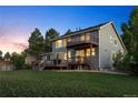 Spacious backyard featuring a well-manicured lawn, two decks, perfect for outdoor entertaining at 10039 Heatherwood Pl, Highlands Ranch, CO 80126