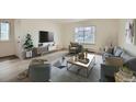 Bright living room featuring modern decor, neutral paint, a large window, and contemporary furnishings at 1117 Elysian Field Dr # A, Lafayette, CO 80026