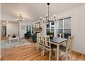 Bright dining room with hardwood floors, fireplace, and adjacent living area offers space for entertaining and Gathering meals at 8543 Redstone St, Highlands Ranch, CO 80126