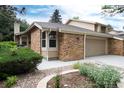Two-story brick home with attached garage, manicured front yard, and well-maintained landscaping at 8543 Redstone St, Highlands Ranch, CO 80126