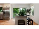 Eat-in kitchen with stainless steel refrigerator and sliding glass doors leading to outdoor space at 8543 Redstone St, Highlands Ranch, CO 80126