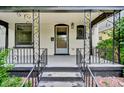 Inviting front porch featuring decorative ironwork and a classic entry door at 2411 N High St, Denver, CO 80205