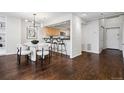 Modern dining area featuring a stylish chandelier and open access to the kitchen at 930 Acoma St # 108, Denver, CO 80204