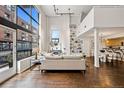 Spacious living room with tall ceilings, hardwood floors, and open floor plan at 930 Acoma St # 108, Denver, CO 80204