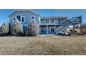 Home featuring a deck with awning and stairs leading down to backyard at 14701 Yosemite St, Brighton, CO 80602
