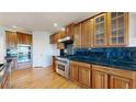 Gourmet kitchen boasts custom cabinets, sleek countertops, and stainless steel appliances at 14701 Yosemite St, Brighton, CO 80602