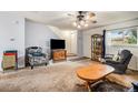 Spacious living room with a staircase, comfortable seating, and a large TV at 1282 S Troy St, Aurora, CO 80012
