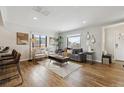 Bright living room features an open floor plan, neutral paint, and hardwood floors at 2222 Galena St, Aurora, CO 80010