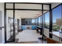 Open sunroom with floor-to-ceiling windows and city and mountain views at 3131 E Alameda Ave # 1003, Denver, CO 80209