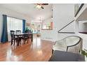 Spacious living and dining areas featuring hardwood floors, high ceilings, and a staircase leading to the upper level at 21733 Saddlebrook Dr, Parker, CO 80138