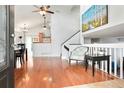 Bright, open-concept living area with hardwood floors, high ceilings, and seamless transition to dining and kitchen spaces at 21733 Saddlebrook Dr, Parker, CO 80138