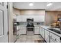 Bright kitchen with white cabinets, stainless steel appliances, and a modern backsplash at 2428 W 82Nd Pl # 1D, Westminster, CO 80031