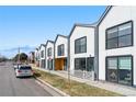 Contemporary row of townhomes showing a sleek modern design and well-kept lawns in a vibrant neighborhood setting at 1907 W Elk Pl # 4, Denver, CO 80211